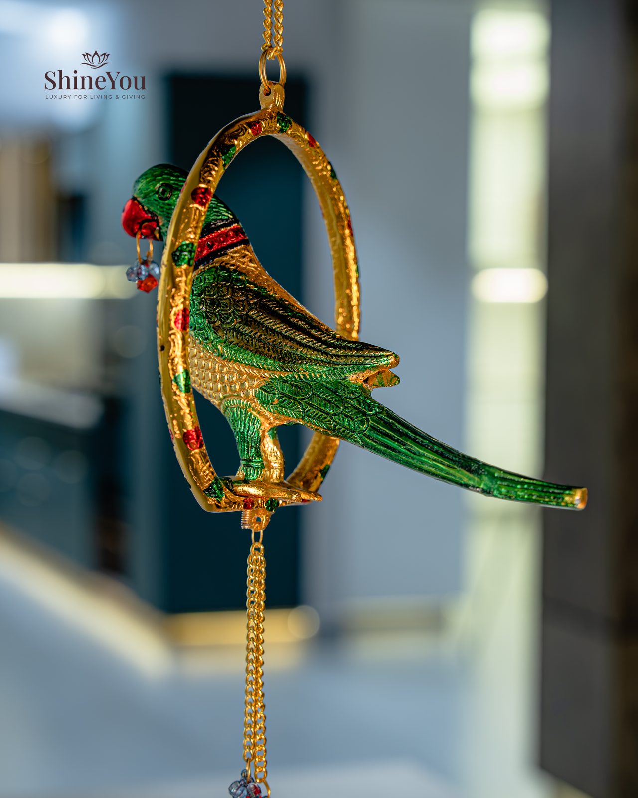 Enamelled parrot hanging in a brass ring